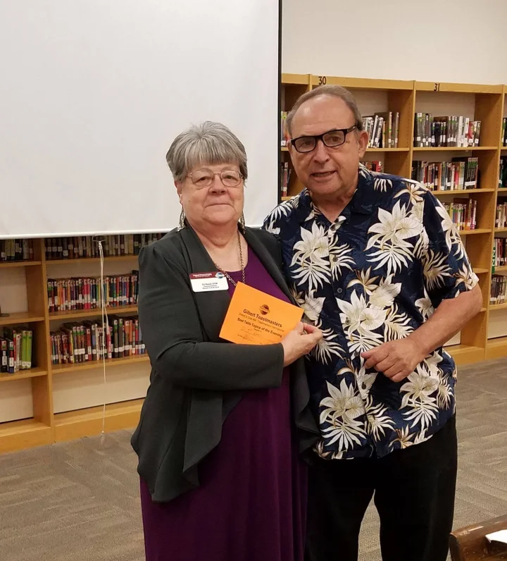 DJ Reed, DTM, presenting a Best Table Topics certificate alongside longtime member Vince DiFranco at a Gilbert Toastmasters meeting