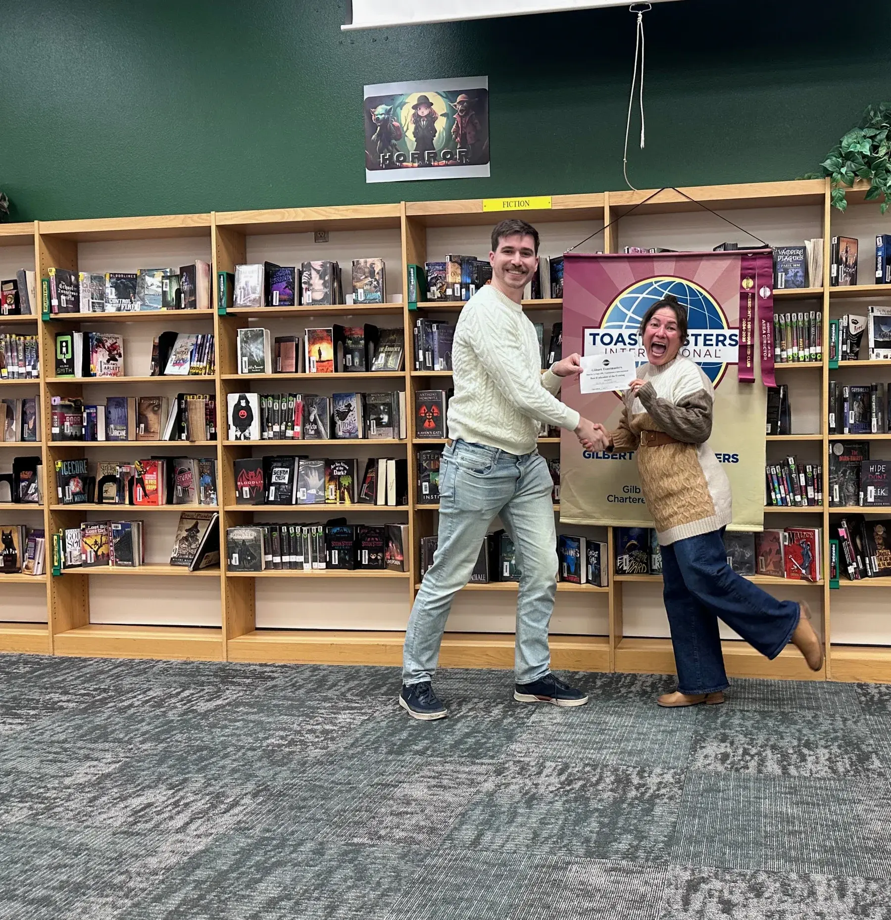 A Gilbert Toastmasters member celebrates with her evaluator after a speech